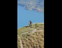 Couple walk mountain top tripod camera video