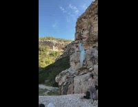 Blue skirt girl rock orange surfboard lake