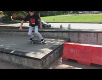 Collab ShredSlams - Skater grinds on orange street barrier, falls off skateboard, and hits head on ground, airpod falls out ear