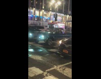 Blue lowrider car turns on hydraulics and bounces on the street