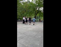 People hold hands and dance in line 