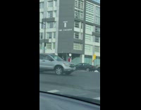 Man ride bike balance tire on head road