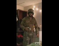 Guy plays video games with girl military 