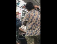 Woman yellow shirt carries iguana on shoulder on subway train