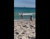 Woman in a bikini sexy poses at the beach shore