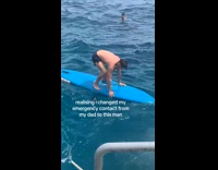 Man struggles to get balance on surfboard