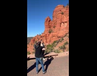 Woman sings for video front of canyon