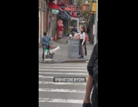 Two women holding hair of woman throwing up in trash can