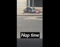 Guy sleeps sidewalk metal pole nap time 