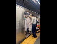Women bring wheelbarrow with vegetables inside subway train