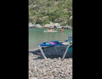 Woman black bikini lie down surfboard beach