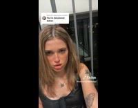 Girl in black dress misreading hate comment