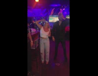 Guy and girl both shotgun a beer except guy spills beer