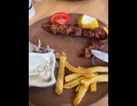 Cat tongue out near filmer with food