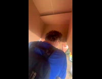 Guys walk on street under box while raining