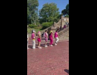 Group of dancers in a line at the park