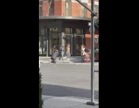 Woman with black bikini under trench coat at the sidewalk