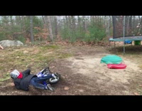 Boy rides blue dirt bike up ramp fail 