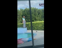 Girl blue shirt weird dance ledge pool