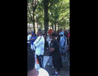 Bear mascot drinks from water bottle at basketball game 