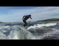 Guy rides board in ocean water