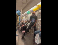 Guy joins person costume performing inside train
