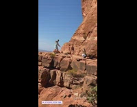 Guy white shirt dance rock trail cliff