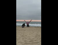 Woman headstand leg split circle pattern beach