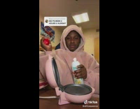 Student cooks eggs and sandwich at dorm 