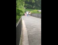 Family meet hug at bridge foreign music