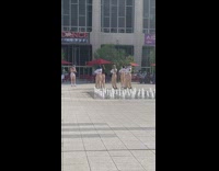 Group women khaki pants dance water fountain