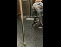 Black sweater lady files nails backpack subway 