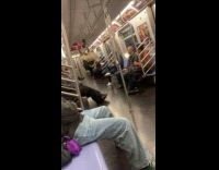 Man pole dancing on the subway railings
