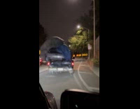 Pickup truck carries broken car on trunk