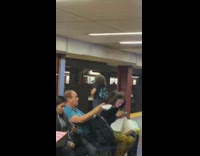 Woman sings loudly with headphones on in subway station