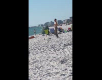 Man shirtless brown pants belly dance beach