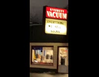 Man shows vacuum store with funny signage 