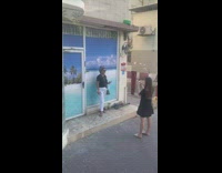 Woman black top white pants beach background store