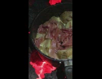 Guy cooking raclette cheese and prosciutto on lava
