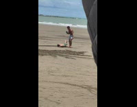Man shirtless lie down sand aerial drone shot