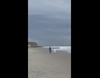 Woman white skirt dance and spin beach overcast