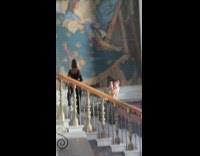 Woman in black top poses at the museum stairs