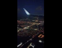 Airplane Flies Over Suburban Neighborhood and Tilts 