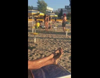 Black bikini girl blue yellow umbrella sand