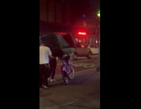 Men transporting couch using bike 