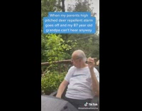 Family at table outside covering their ears except for grandpa