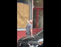 Man gray shirt parrot on shoulder street