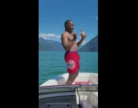 Guy dances with drink on yacht 