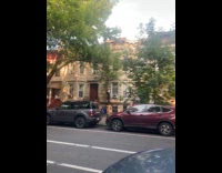 Man on stilts walking on sidewalk