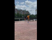 Man black top khaki shorts walk park